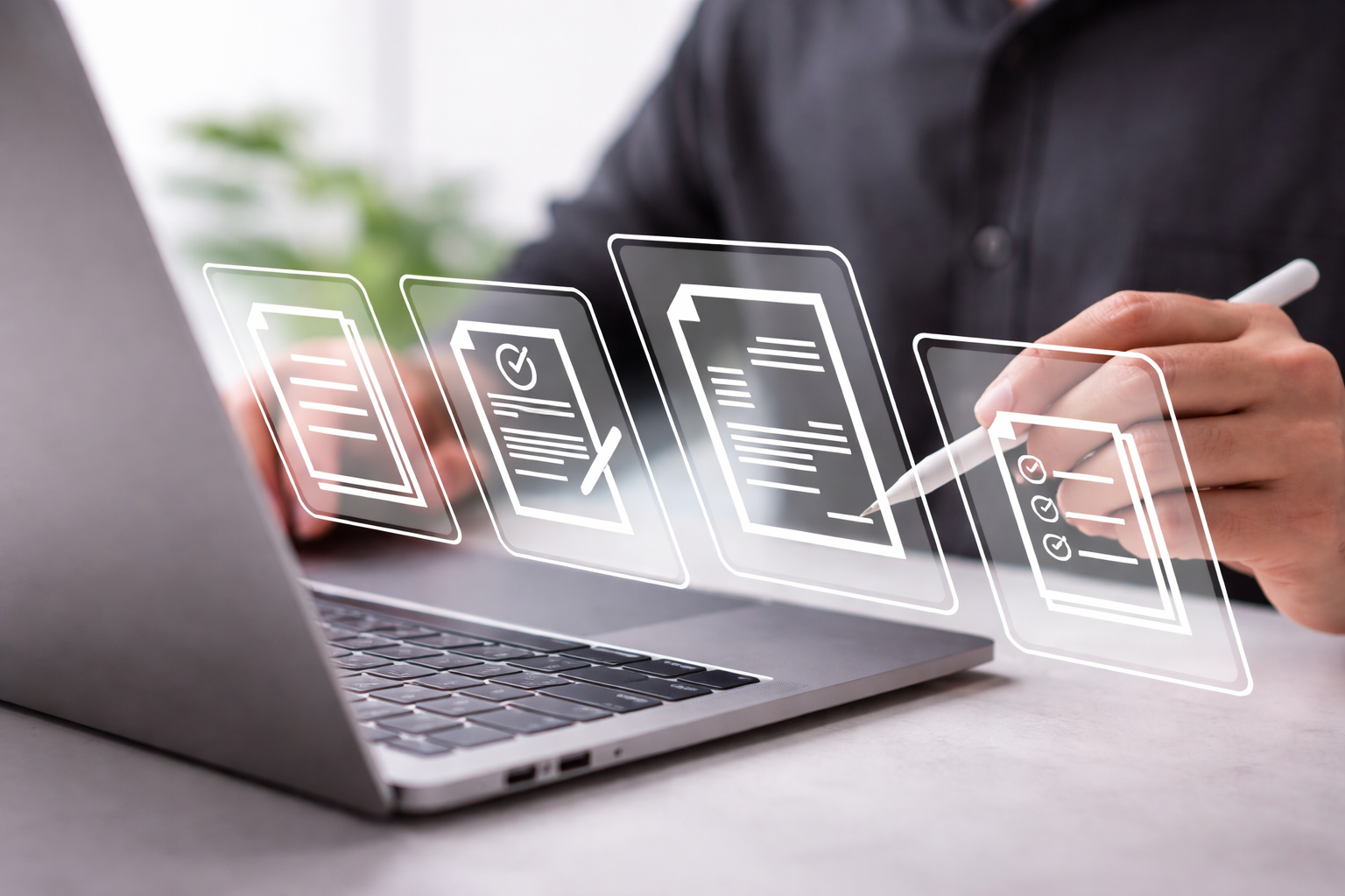 A person seated at a desk working on a laptop, holding a stylus while interacting with floating digital document icons displayed in front of the computer. The icons represent tasks such as forms, checklists, and contracts. The scene suggests digital documentation or workflow processing in a modern office environment.