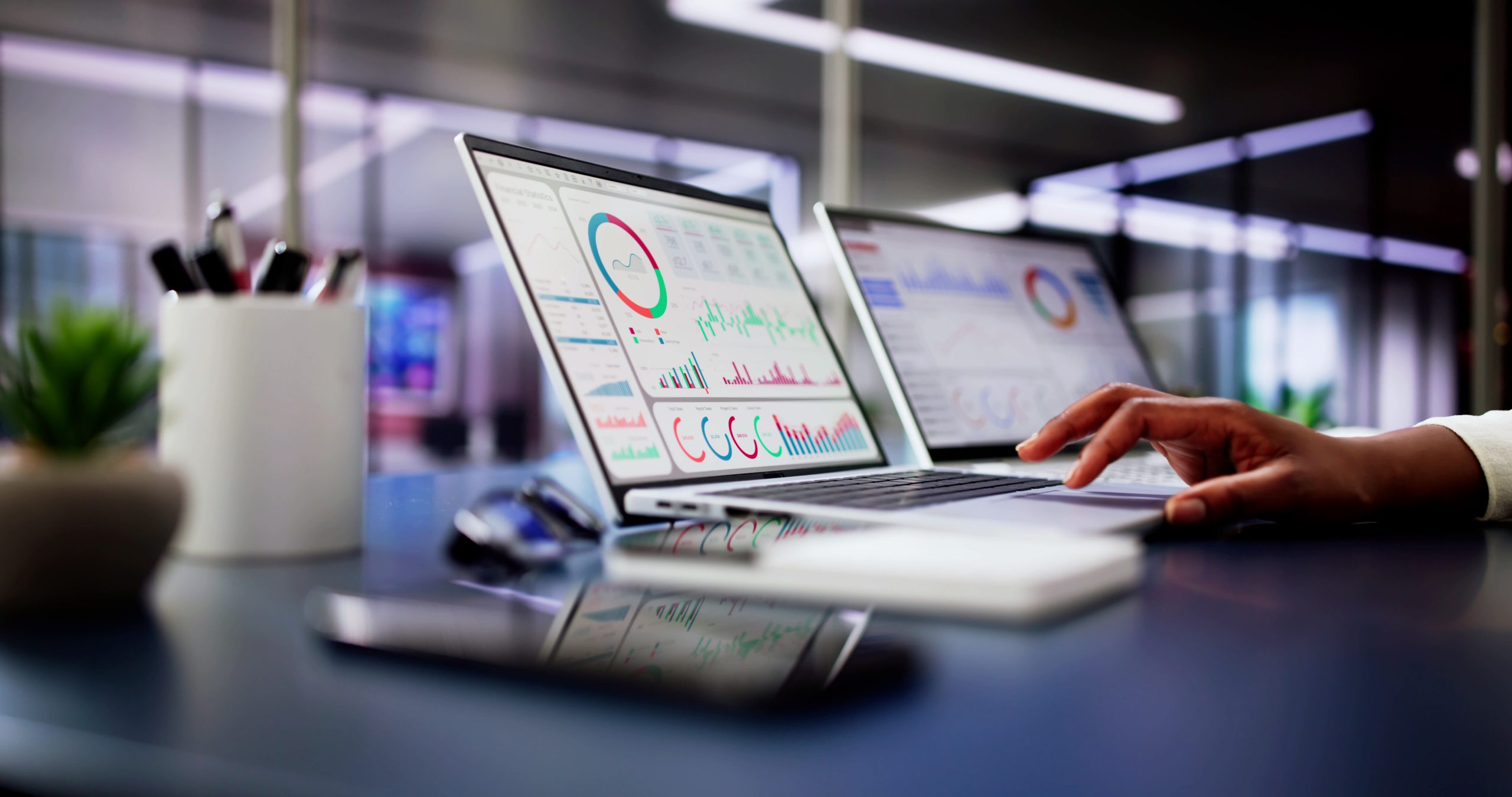 Female African American Data Analyst Predicting Market Trends on Virtual KPI Dashboard in Emerging Financial Business Concept.